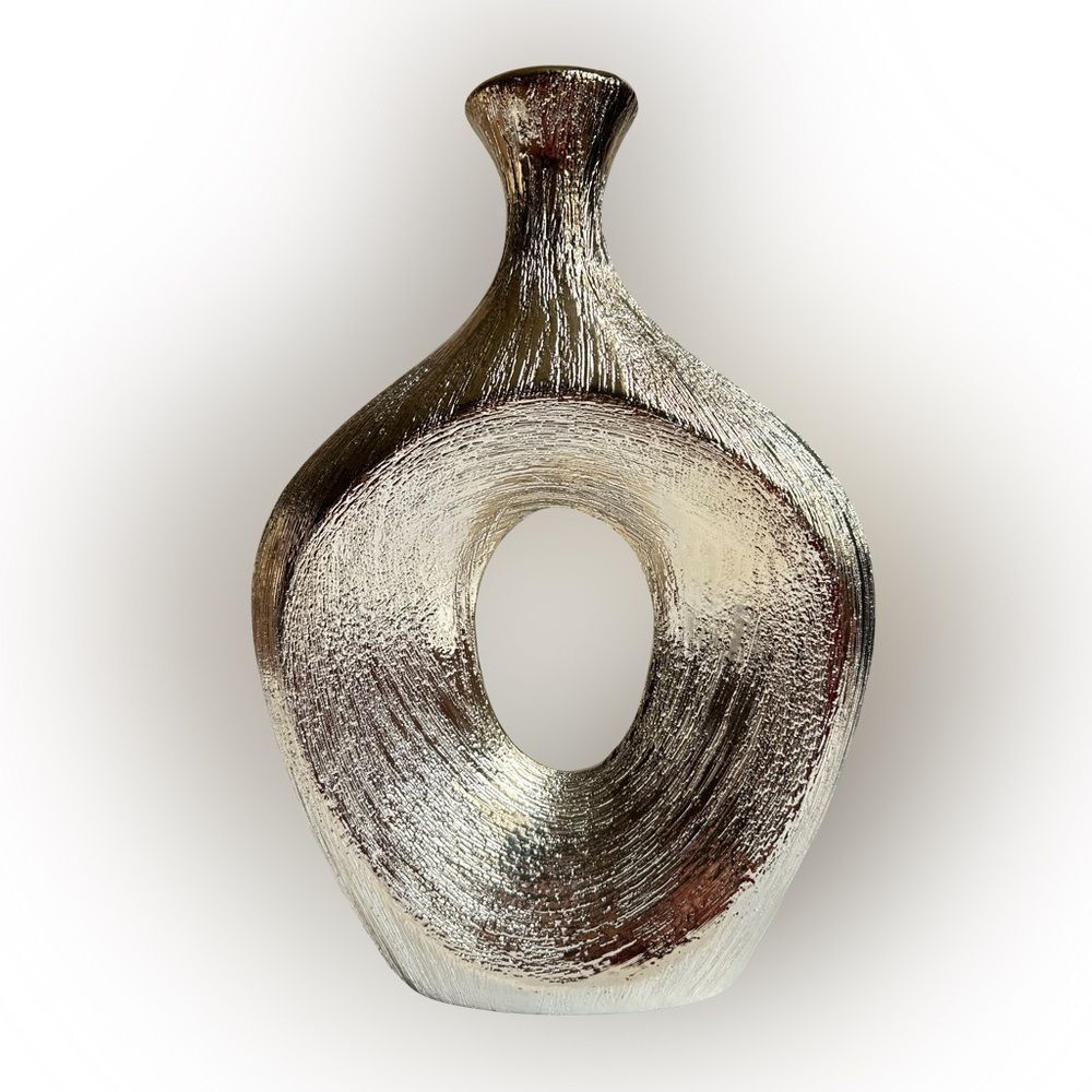 Textured silver vase, geometric oval shape with center cut out. Modern, sleek.